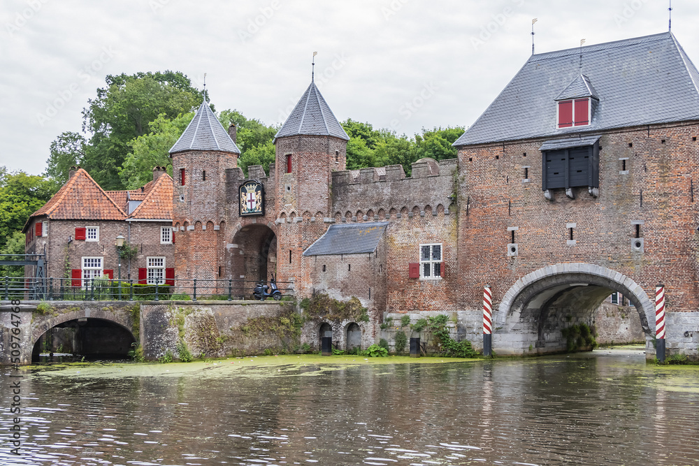 Picturesque medieval fortress city wall gate Koppelpoort and Eem River in the city of Amersfoort. Gate was built between 1380 and 1425, it combines land and water-gates. Amersfoort, the Netherlands.