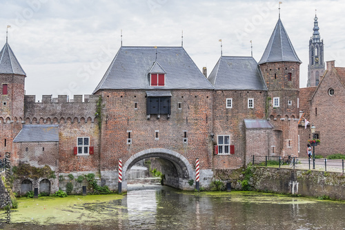 Picturesque medieval fortress city wall gate Koppelpoort and Eem River in the city of Amersfoort. Gate was built between 1380 and 1425, it combines land and water-gates. Amersfoort, the Netherlands. photo