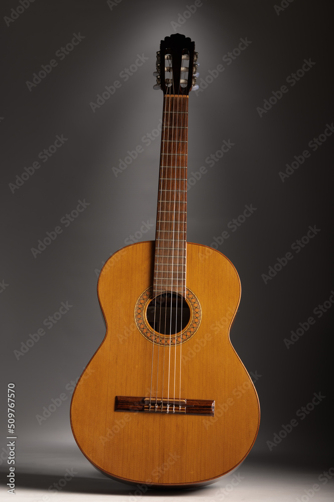 Classical guitar on grey background with copy space Classical guitar on grey background with copy space