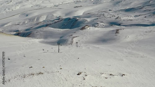 Aerial view snow mountain range landscape clouds in background 4k winter drone footage Ski resort. Erciyes. Turkey. Volcano. Ropeway. aerial truck left. High quality 4k footage