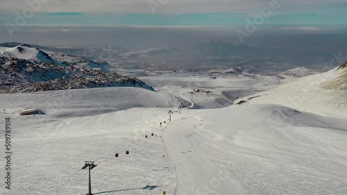 Aerial view snow mountain range landscape clouds in background 4k winter drone footage Ski resort. Erciyes. Turkey. Volcano. Ropeway. aerial truck left. High quality 4k footage