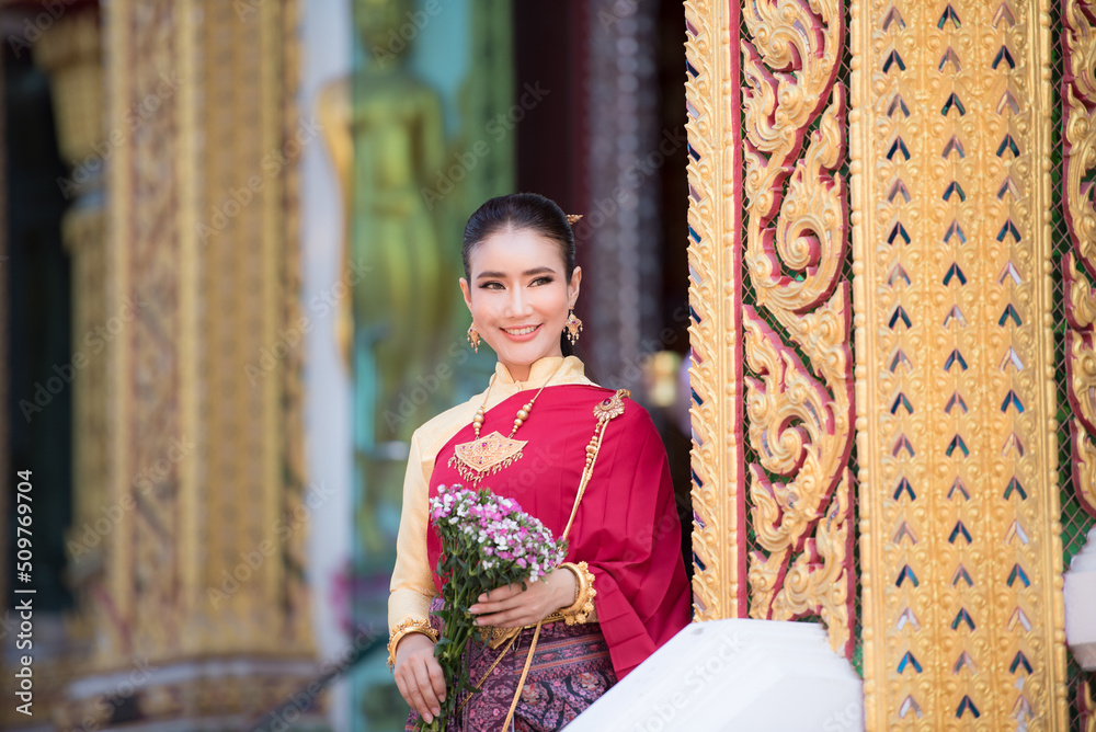 Portrait of young Asian women in traditional Thai costumes worshiping Buddha images with flower garlands. Preserving the good culture of Thai people during Songkran Festival, Thai New Year, April Fami Portrait of young Asian women in traditional Thai costumes worshiping Buddha images with flower garlands. Preserving the good culture of Thai people during Songkran Festival, Thai New Year, April Fami