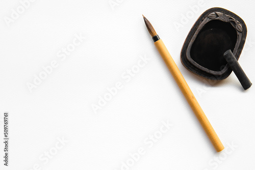 Abstract calligraphy brush with inkstone on white background. picture for add text or greeting card chinese new year. Chinese traditional painting text