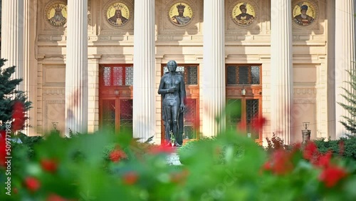 Close view of Romanian Athenaeum in Bucharest, Romania. Main building, square with a statue in front of it, greenery photo