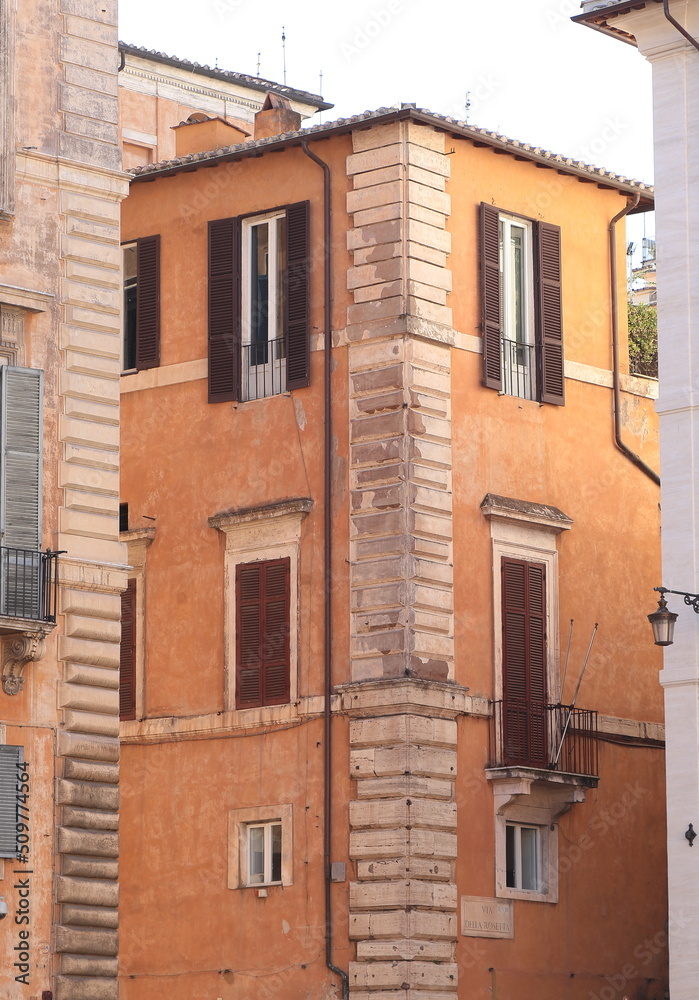 Traditional Orange Brown Building Facade Detail with Windows and Street Sign in Rome, Italy