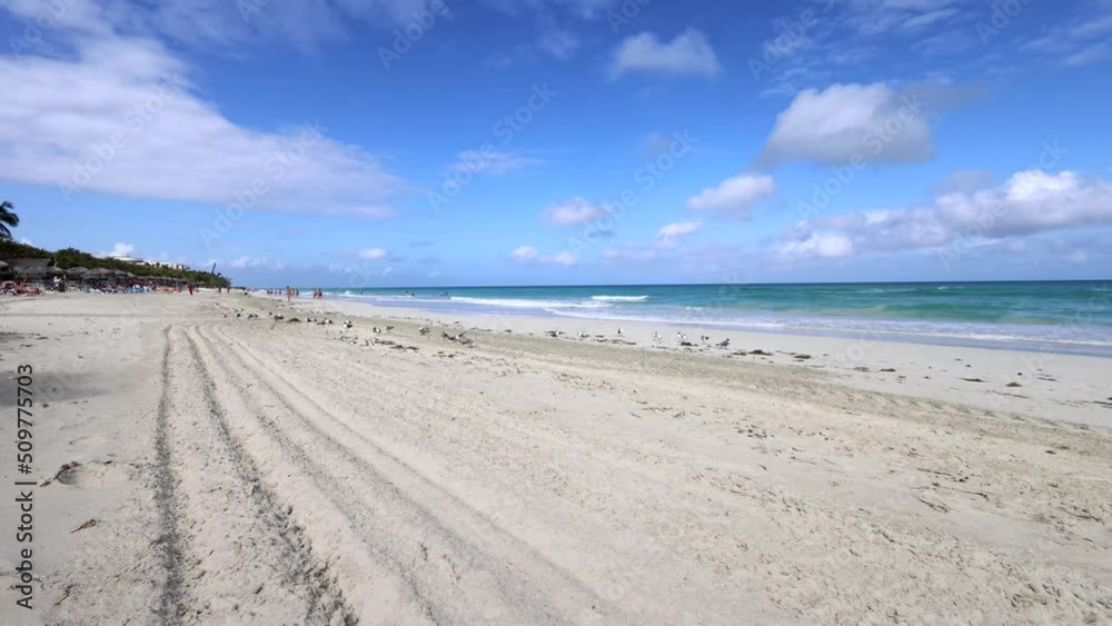 The beautiful beach front of the Cuban beach at Varadero in Cuba showing the waves and clean ocean waters with white clouds in the sky in the summer filmed in 8k quality The beautiful beach front of the Cuban beach at Varadero in Cuba showing the waves and clean ocean waters with white clouds in the sky in the summer filmed in 8k quality