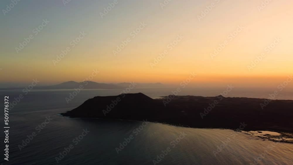 Aerial panning clip of a stunning sunrise over the volcanic island of Lobos Fuerteventura Aerial panning clip of a stunning sunrise over the volcanic island of Lobos Fuerteventura