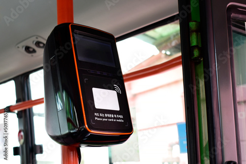 한국의 대중교통버스를 이용할때 요금을 지불하는 카드단말기이다. 한국어와 영어가 써있으며 카드또는 휴대폰을 위치시켜달라고 써있다.