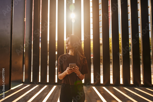 Content businesswoman standing with mobile phone