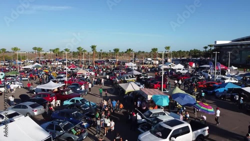 aerial flight through a car event in a large parking lot