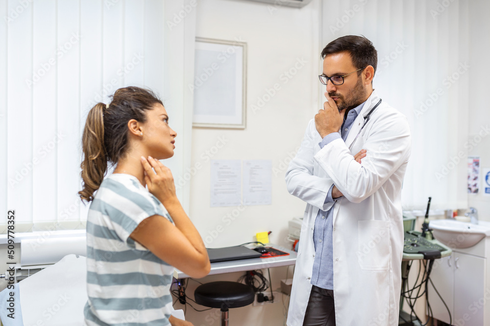 Woman having a neck pain. Doctor working in the office and listening to the patient, she is explaining her symptoms, healtcare and assistance concept Woman having a neck pain. Doctor working in the office and listening to the patient, she is explaining her symptoms, healtcare and assistance concept