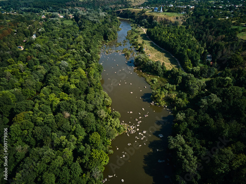 Aerial view of Southern Bug river and granite mountains, summer landscape of forest on the shore, Famous place for rafting and kayaking , Ukraine