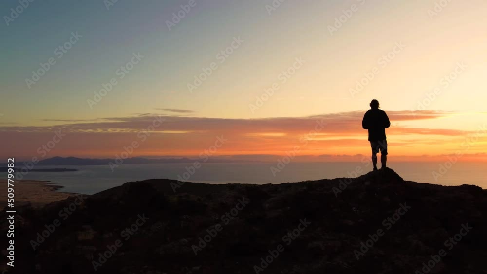 Aerial panning clip of the beautiful sunrise view from the top of Montana Roja volcanic mountain Corralejo Fuerteventura Aerial panning clip of the beautiful sunrise view from the top of Montana Roja volcanic mountain Corralejo Fuerteventura