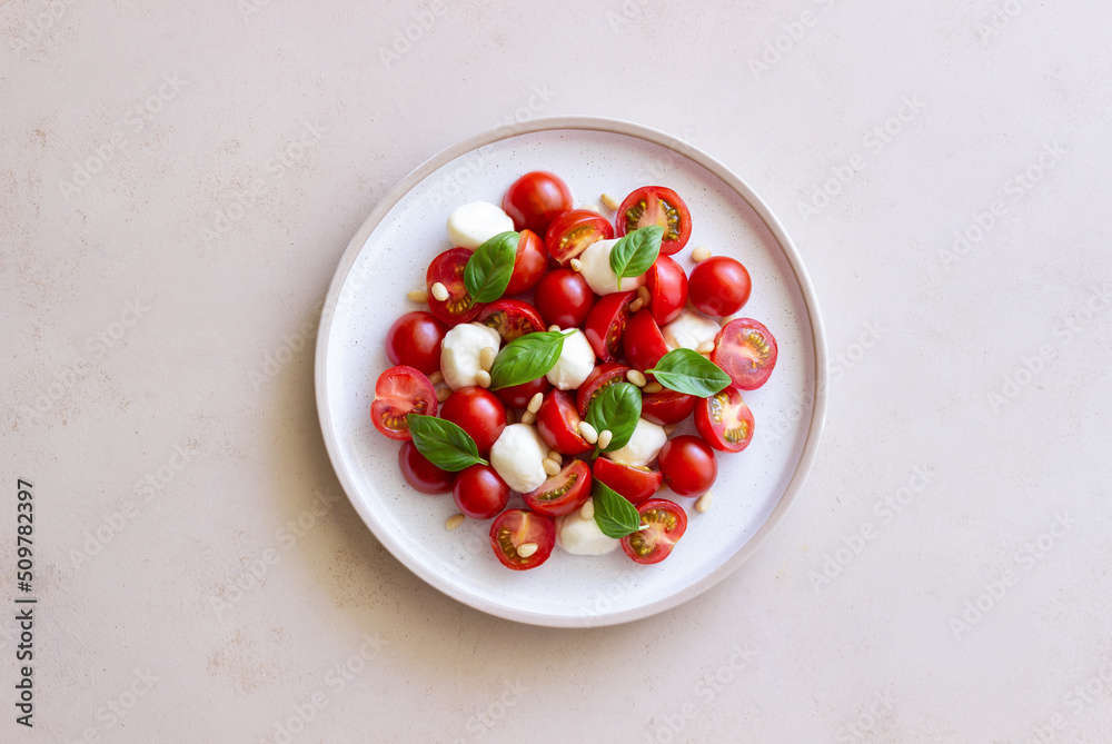 Salad with mozzarella, tomatoes, nuts and basil. Healthy eating. Vegetarian food. Diet. Salad with mozzarella, tomatoes, nuts and basil. Healthy eating. Vegetarian food. Diet.