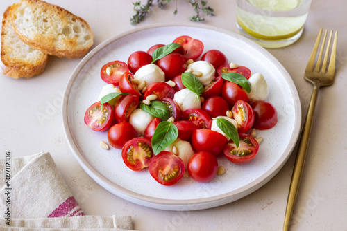 Salad with mozzarella, tomatoes, nuts and basil. Healthy eating. Vegetarian food. Diet.