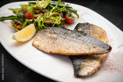 Two baked mackerel fillets on a plate