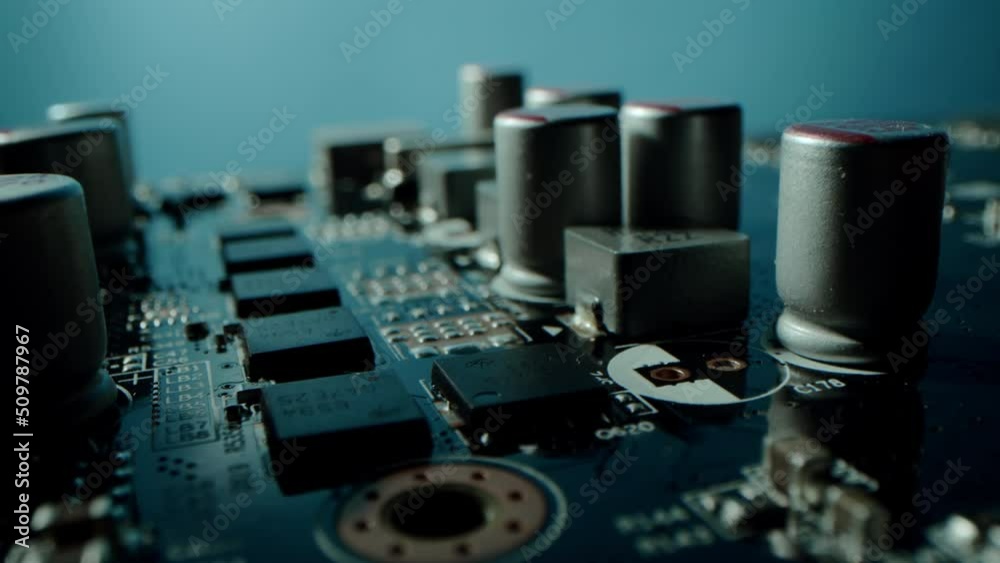 Close up detail of electronic components on PC. Macro dolly shot side view of a computer electrical circuit with cip, slots, microchip and microprocessors, board with transistors and microchips Close up detail of electronic components on PC. Macro dolly shot side view of a computer electrical circuit with cip, slots, microchip and microprocessors, board with transistors and microchips