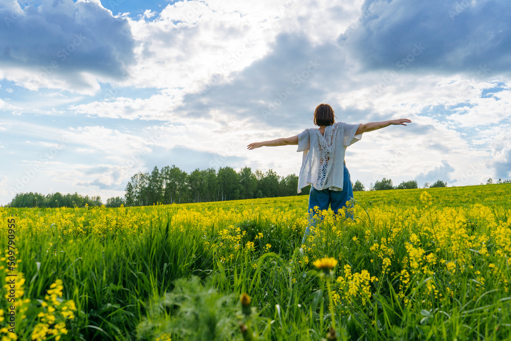 a young girl in a boho cape against the blue sky spread her arms like a pilot a young girl in a boho cape against the blue sky spread her arms like a pilot