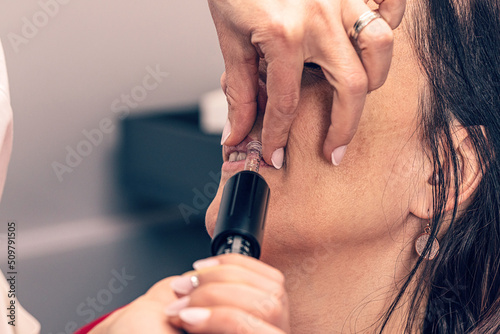Cosmetologist makes microinjections photo