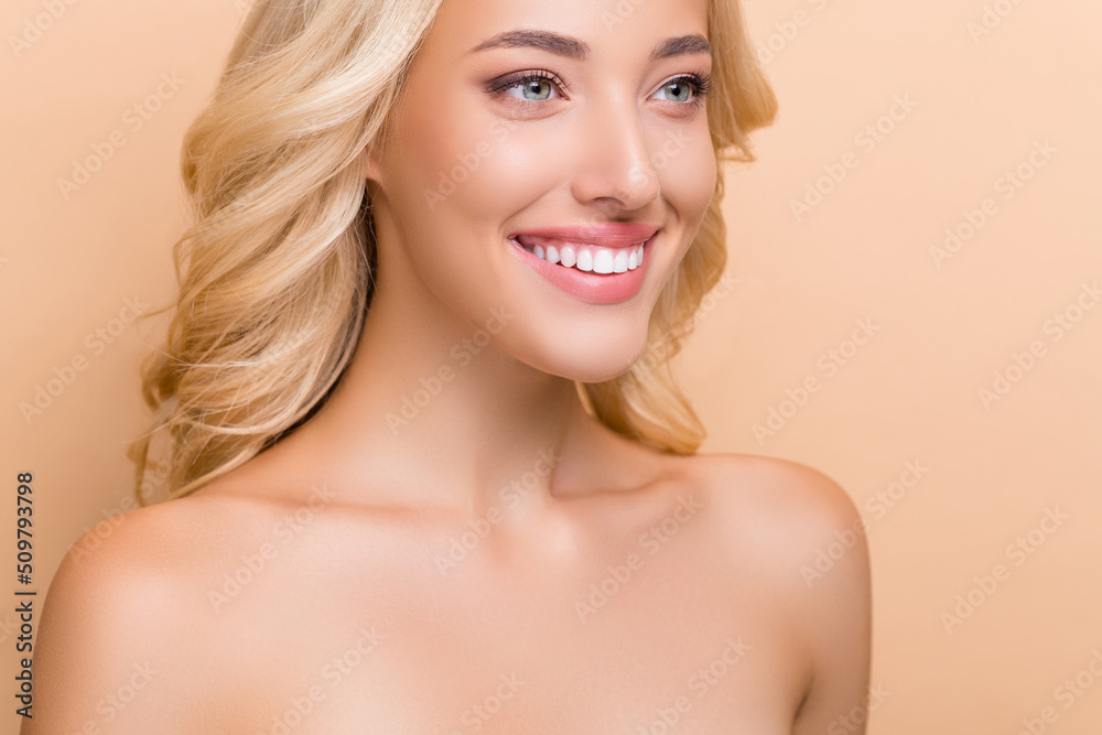 Cropped view portrait of attractive cheerful wavy-haired woman flawless pore harmony isolated over beige pastel color background Cropped view portrait of attractive cheerful wavy-haired woman flawless pore harmony isolated over beige pastel color background