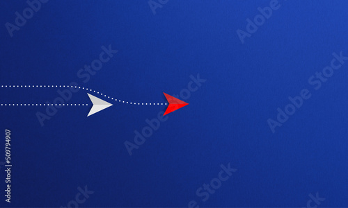 Red paper plane overtakes another white paper plane on blue background. Innovation concept.