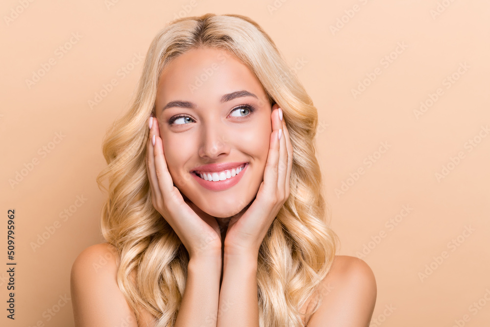 Portrait of attractive cheerful wavy-haired girl touching silky skin foundation copy space isolated over beige pastel color background Portrait of attractive cheerful wavy-haired girl touching silky skin foundation copy space isolated over beige pastel color background