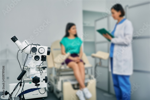 Women's health, colposcopy, gynecology. Woman patient sitting in gynecological chair during consultation with her gynecologist in medical clinic