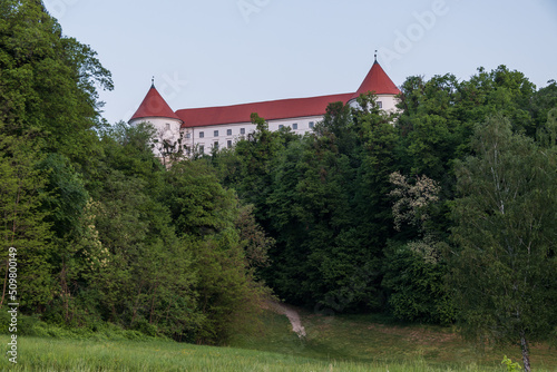 Castle Mokrice on a spring evening with dramatic clouds and forest. A fortress in the woods. 

 photo