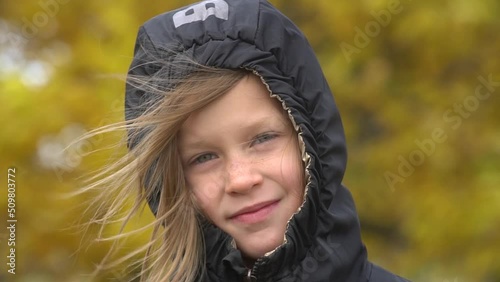 Closeup portrait of happy adorable child girl smiling. Slow motion. photo