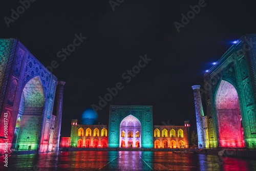 Registan square in Samarkand lit in colourful lights, Uzbekistan photo