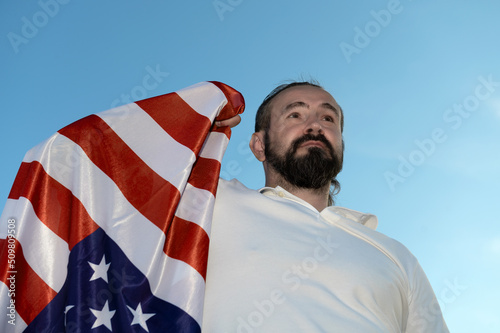 Patriot hipster man holding emotionally american USA flag.