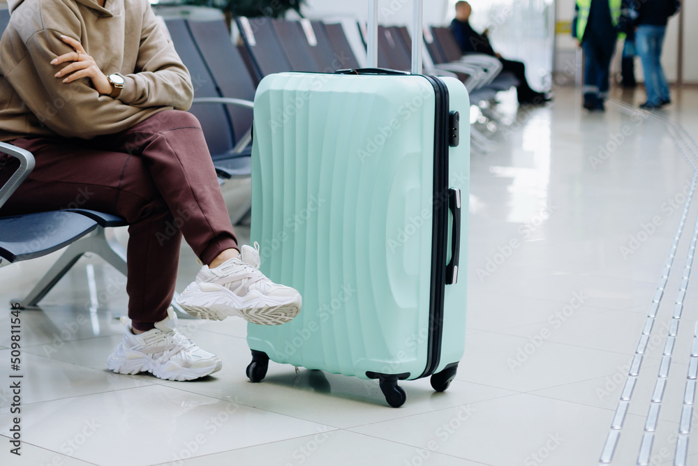 cropped image of a woman sitting in an airport waiting room .