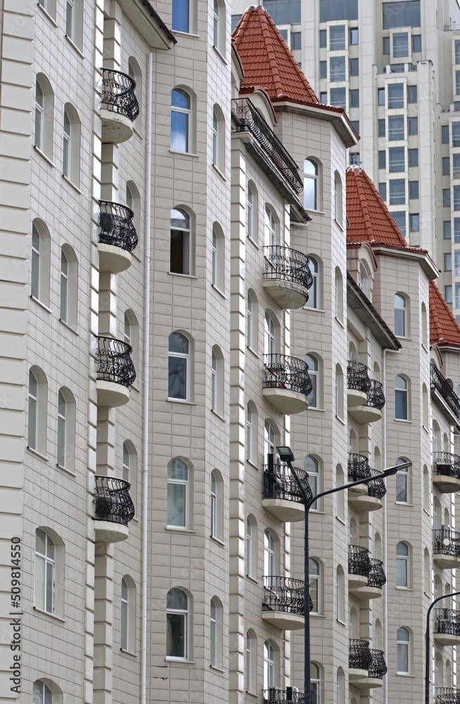 Fragment of the facade of a multi-storey residential building on a summer day