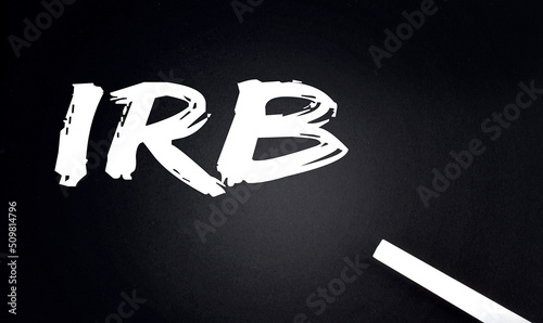 IRB Industrial Revenue Bond text on Black Chalkboard with a piece of chalk photo