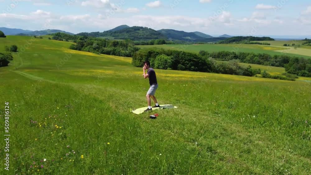 young boxer prepares for his fight on top of a hill on a sunny day. Boxing training of an athlete. A test of endurance, flexibility and punching speed. 4k video