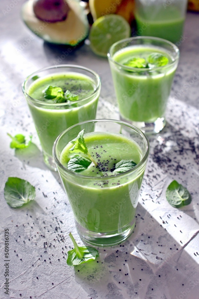 Healthy green smoothie with avocado, banana and spinach. Top view. Detox drink. Healthy green smoothie with avocado, banana and spinach. Top view. Detox drink.