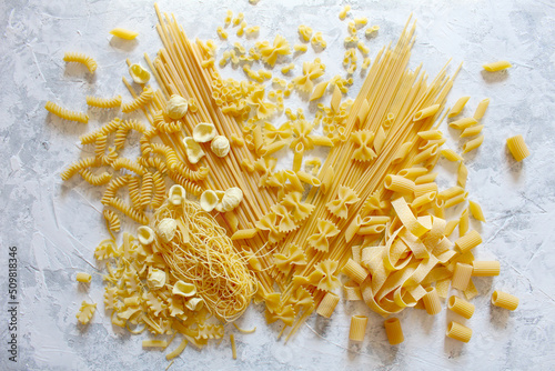 Variety Italian pasta on light background. Top view.