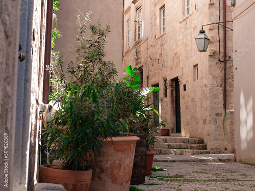 old town street view, stone buildings, hot summer day, narrow streets © Ela