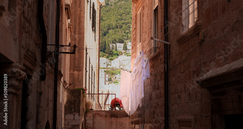 Old European street view in Croatia, laundry white on ropes on windows photo