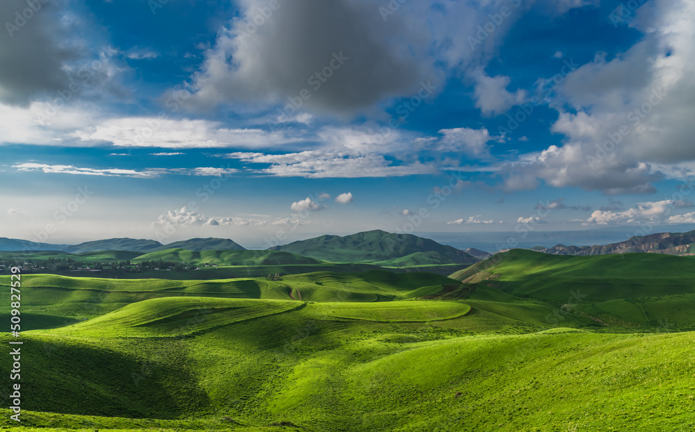 Mountain green valley and cloudy sky.Pasture in mountain valley.Mountain landscape.Natural background.