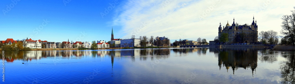 weites Panorama vom Schweriner Schloss am schönen Burgsee mit blauem Himmel und weißen Wolken 