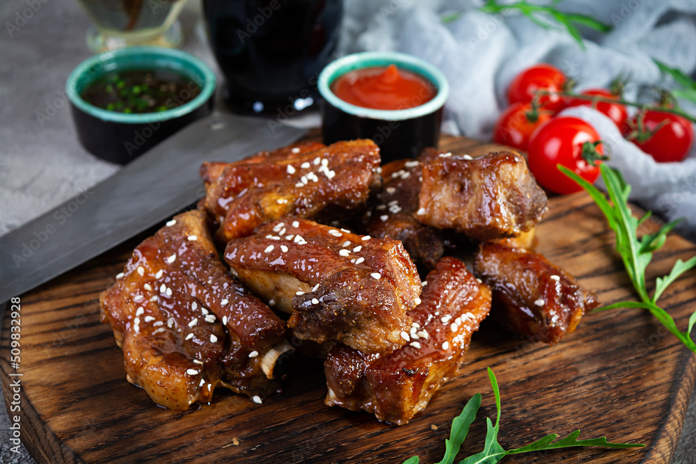 Grilled sliced ribs in sweet and sour sauce. Ribs marinated in honey sauce with herbs