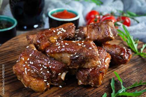 Grilled sliced ribs in sweet and sour sauce. Ribs marinated in honey sauce with herbs
