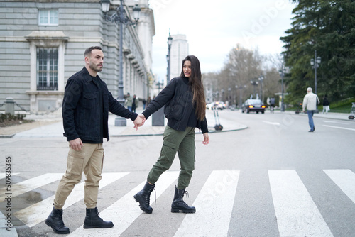 Couple walking on pedestrian crossing photo