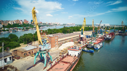 Aerial view of cranes in a harbor. Bulk carrier on a maintenance at dry dock. River shipyard. Ship repair yard