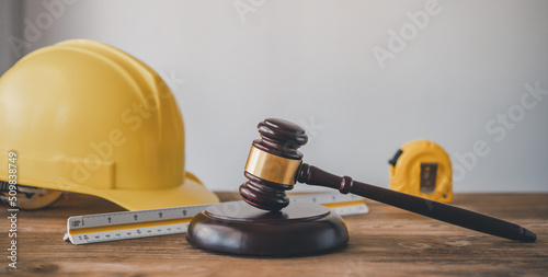 Judge's hammer and helmet Law and Justice about labor law concept Construction law. photo