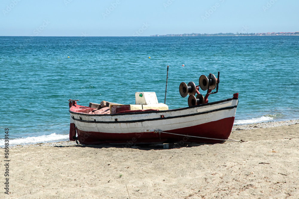 Vintage wooden fishing boat closeup on sand beach