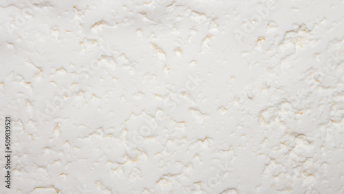 Cottage cheese homemade rustic background top view.The texture of cottage cheese.