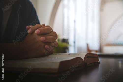 Fotografie, Tablou Hands of a man pray on bible, hope, faith, christianity, religion concept