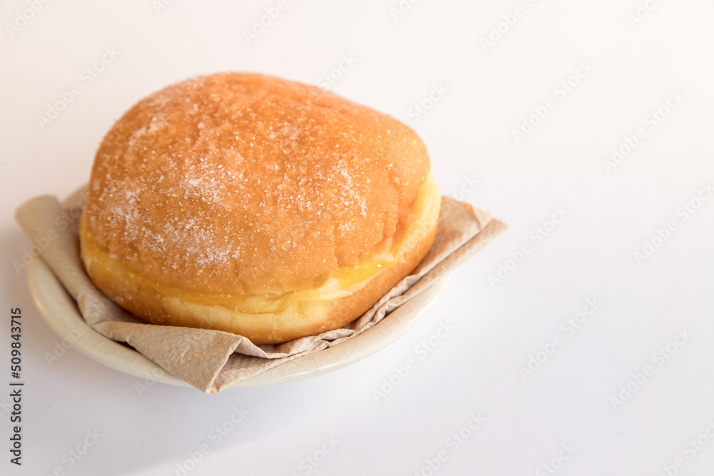Bolas de Berlim, Berliner or donuts filled with egg jam, a very popular dessert in Portuguese pastry shops. Bolas de Berlim, Berliner or donuts filled with egg jam, a very popular dessert in Portuguese pastry shops.
